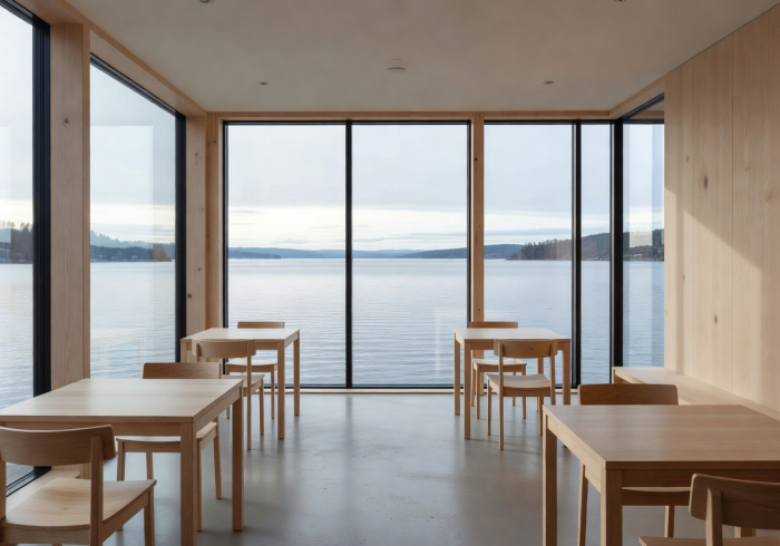 Minimalist Nordic café architecture with clean lines, natural wood, and large windows overlooking water